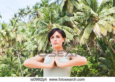 Stock Image - Woman in prayer pose. Fotosearch