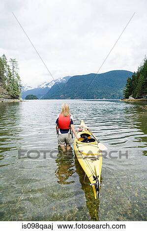 Woman kayaking in fjord View Large Photo Image Stock Image - Woman kayaking in fjord. Fotosearch