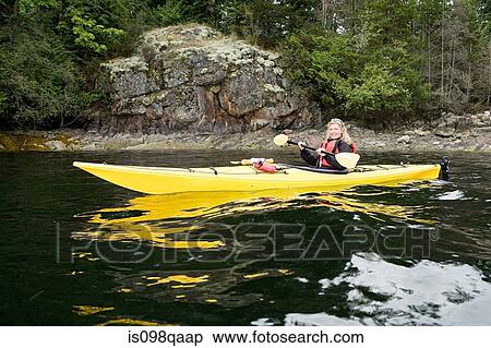 Woman kayaking in fjord View Large Photo Image Stock Photography - Woman kayaking in fjord. Fotosearch