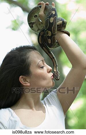 Woman kissing a snake View Large Photo Image Stock Image - Woman kissing a snake. Fotosearch