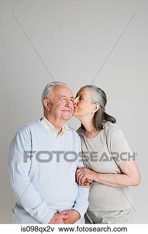 Stock Photo - Woman kissing husband. Fotosearch