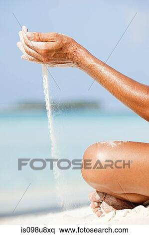 Woman letting sand flow through hands, Maldives View Large Photo Image Stock Photography - Woman letting sand flow through hands, Maldives. Fotosearch