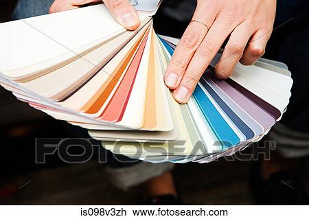 Stock Image - Woman looking at color swatch. Fotosearch