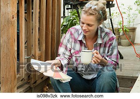 Woman looking at color swatch View Large Photo Image Stock Image - Woman looking at color swatch. Fotosearch