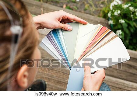 Stock Photo - Woman looking at color swatch. Fotosearch