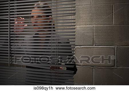 Woman looking through blinds View Large Photo Image Stock Image - Woman looking through blinds. Fotosearch