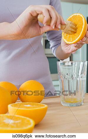 Woman making orange juice View Large Photo Image Stock Image - Woman making orange juice. Fotosearch