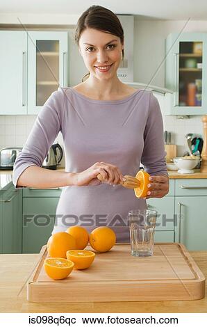 Woman making orange juice View Large Photo Image Stock Image - Woman making orange juice. Fotosearch