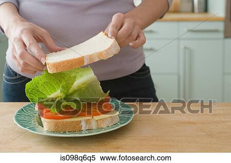 Stock Photography - Woman making sandwich. Fotosearch