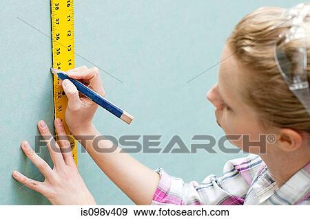 Woman measuring plywood and marking with pencil View Large Photo Image Stock Photo - Woman measuring plywood and marking with pencil. Fotosearch