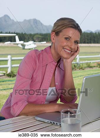 Woman on airfield with laptop View Large Photo Image Stock Photography - Woman on airfield with laptop. Fotosearch