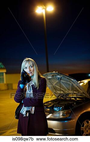 Woman on cellphone with broken down car View Large Photo Image Stock Image - Woman on cellphone with broken down car. Fotosearch