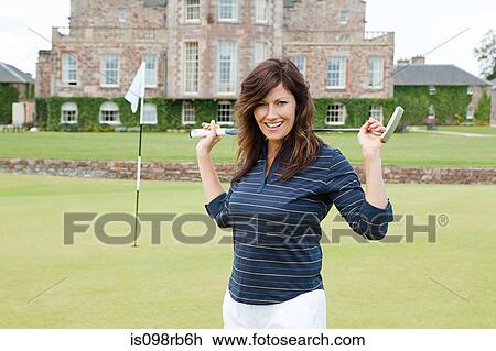 Stock Image - Woman on golf course. Fotosearch