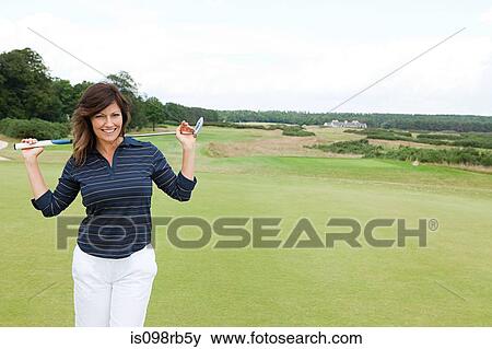 Stock Photo - Woman on golf course. Fotosearch