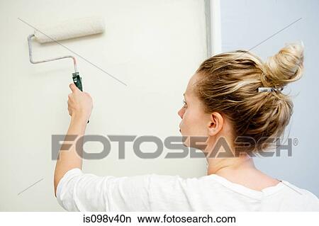 Picture - Woman painting wall. Fotosearch