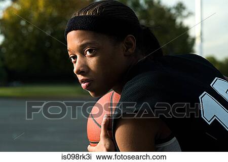 Stock Image - Woman playing basketball. Fotosearch