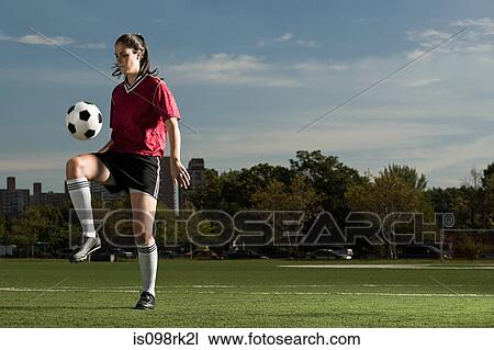 Stock Image - Woman playing keepy uppy. Fotosearch