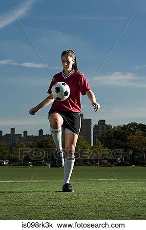 Stock Image - Woman playing keepy uppy. Fotosearch