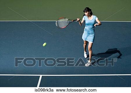 Stock Image - Woman playing tennis. Fotosearch
