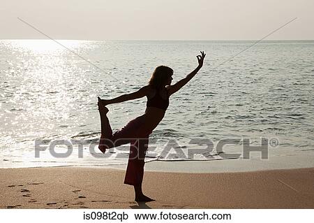 Woman practicing yoga by sea ay sunset View Large Photo Image Stock Image - Woman practicing yoga by sea ay sunset. Fotosearch