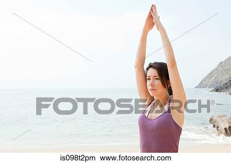 Woman practicing yoga by the sea View Large Photo Image Picture - Woman practicing yoga by the sea. Fotosearch