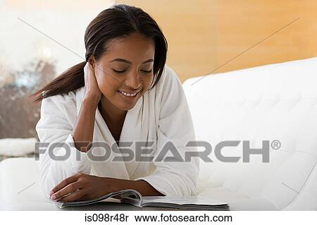 Stock Photography - Woman reading magazine. Fotosearch
