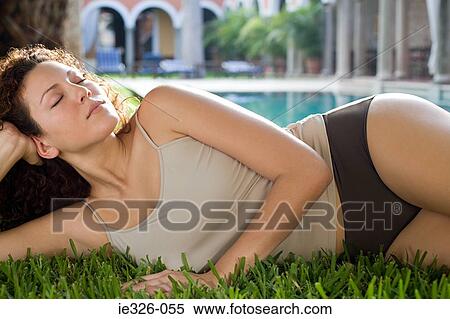Woman relaxing near swimming pool View Large Photo Image Stock Photography - Woman relaxing near swimming pool. Fotosearch