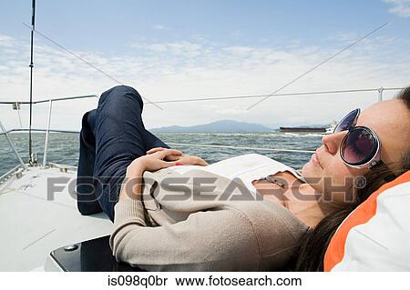 Woman sleeping on a sailboat View Large Photo Image Stock Photography - Woman sleeping on a sailboat. Fotosearch