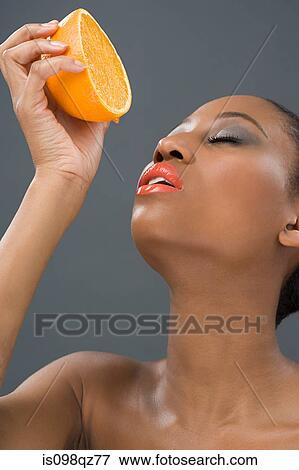 Woman squeezing an orange View Large Photo Image Stock Photo - Woman squeezing an orange. Fotosearch