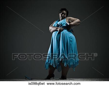 Stock Photograph - Woman struggling with dress. Fotosearch