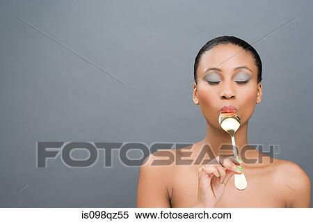 Woman sucking a spoon View Large Photo Image Stock Photography - Woman sucking a spoon. Fotosearch
