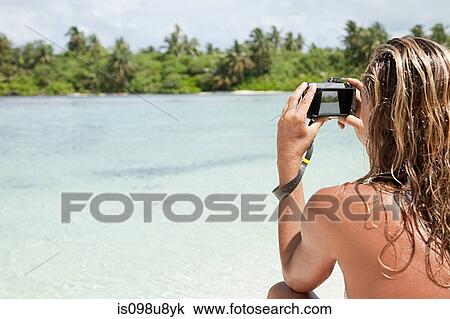 Woman taking picture, Medahutthaa Island, North Huvadhu Atoll, Maldives View Large Photo Image Stock Image - Woman taking picture, Medahutthaa Island, North Huvadhu Atoll, Maldives. Fotosearch