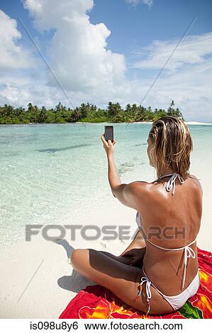 Woman taking picture, Medahutthaa Island, North Huvadhu Atoll, Maldives View Large Photo Image Stock Photograph - Woman taking picture, Medahutthaa Island, North Huvadhu Atoll, Maldives. Fotosearch