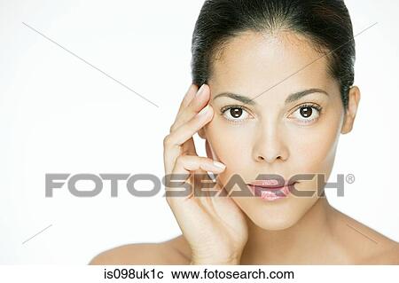 Stock Image - Woman touching her face. Fotosearch