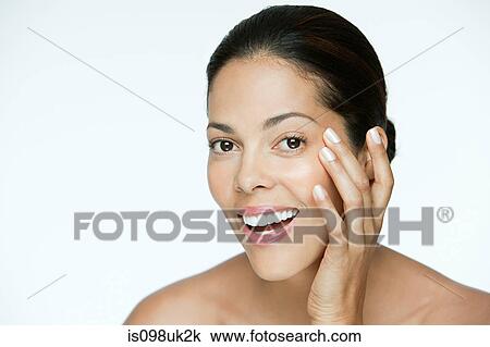 Woman touching her face View Large Photo Image Stock Image - Woman touching her face. Fotosearch