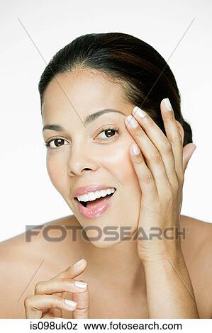 Woman touching her face View Large Photo Image Stock Photo - Woman touching her face. Fotosearch