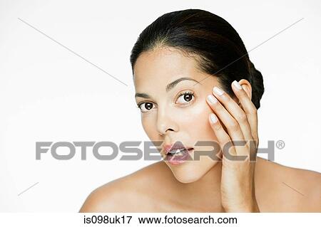 Woman touching her face View Large Photo Image Stock Photo - Woman touching her face. Fotosearch