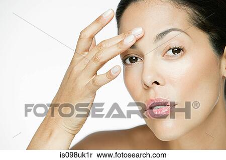 Stock Photography - Woman touching her face. Fotosearch