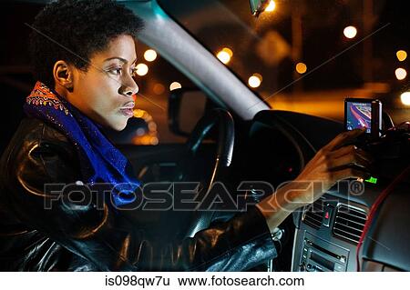 Stock Photograph - Woman using sat nav. Fotosearch