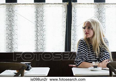Stock Photography - Woman waiting in coffee shop. Fotosearch