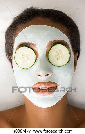 Woman wearing face mask and cucumber View Large Photo Image Stock Photo - Woman wearing face mask and cucumber. Fotosearch