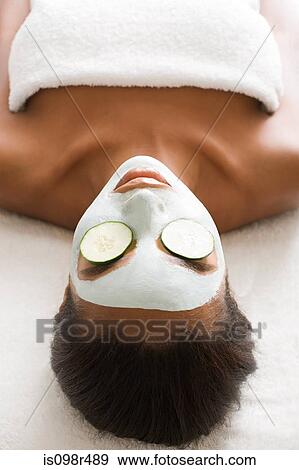 Woman wearing face mask and cucumber View Large Photo Image Stock Photo - Woman wearing face mask and cucumber. Fotosearch