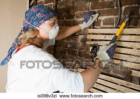 Woman wearing headscarf and mask destroying wall View Large Photo Image Stock Image - Woman wearing headscarf and mask destroying wall. Fotosearch