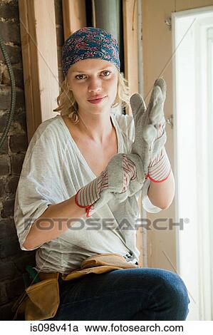 Stock Image - Woman wearing protective gloves. Fotosearch