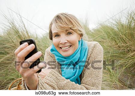 Woman with a smartphone View Large Photo Image Stock Image - Woman with a smartphone. Fotosearch