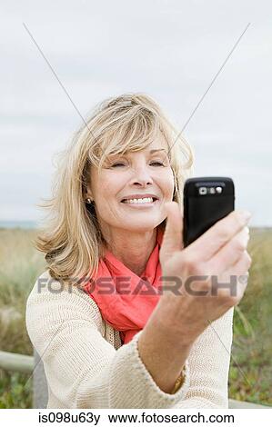 Stock Photo - Woman with a smartphone. Fotosearch