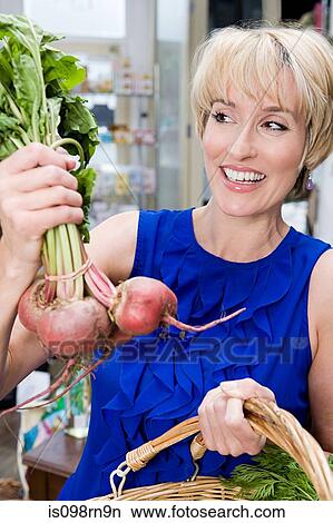 Picture - Woman with beetroot. Fotosearch