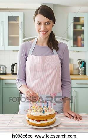 Stock Image - Woman with birthday cake. Fotosearch