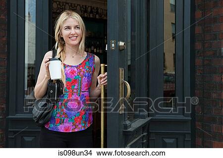 Woman with coffee to go View Large Photo Image Picture - Woman with coffee to go. Fotosearch