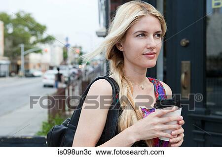 Stock Image - Woman with coffee to go. Fotosearch
